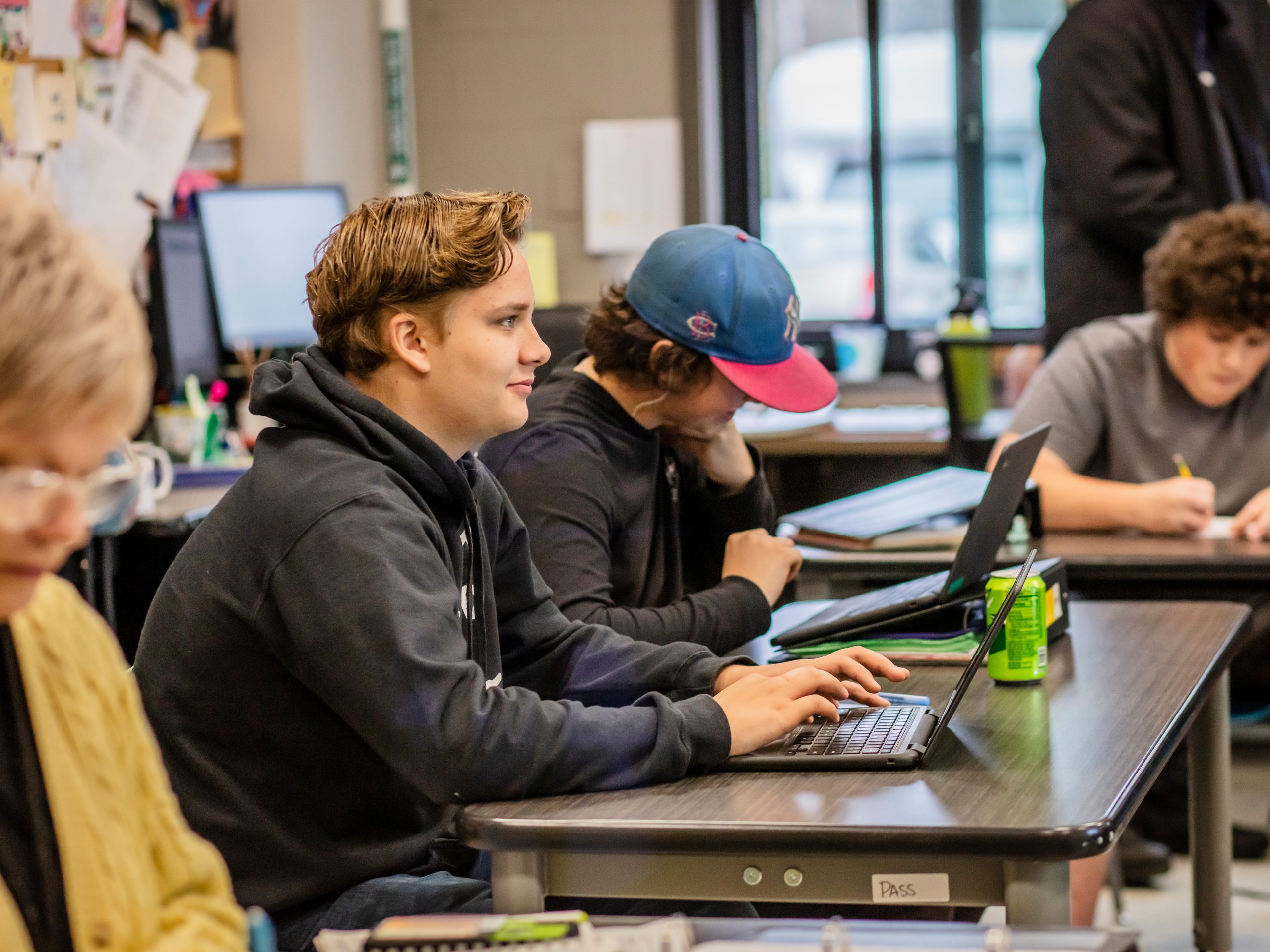 Students working on laptops in classroom