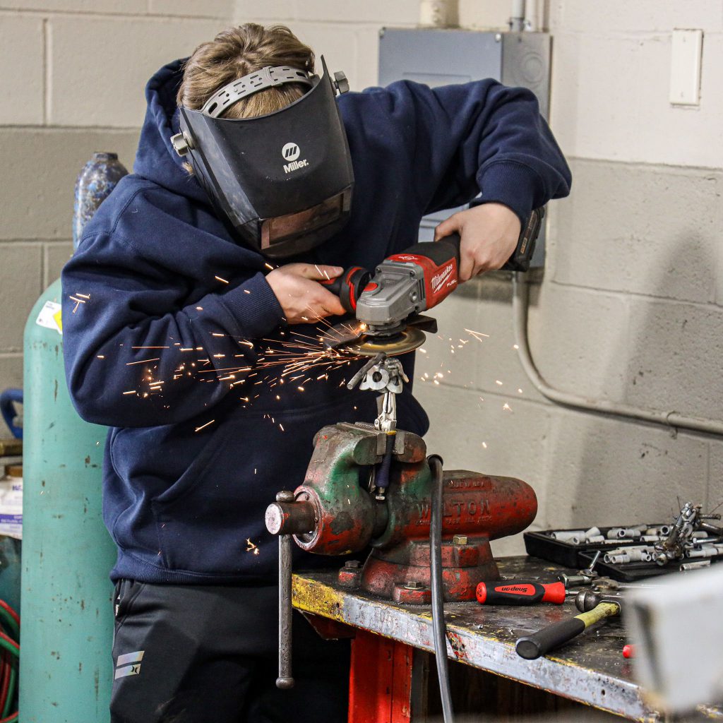Auto trade student cutting metal