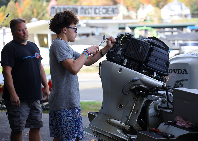 Student intensley working on a machine.