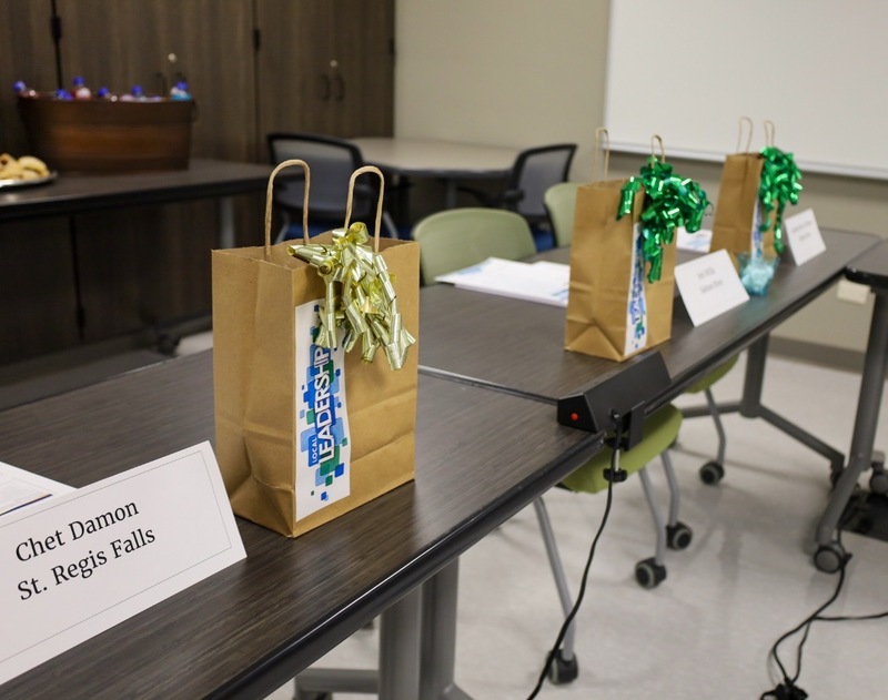 3 paper bags with bows on them.