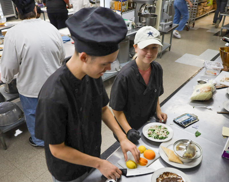 two students cooking together
