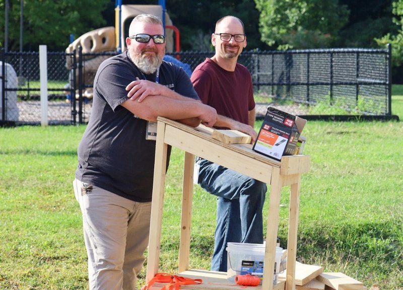 2 instructors smiling together
