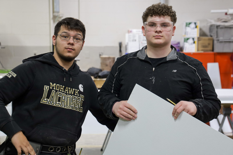 2 students looking at camera with goggles on