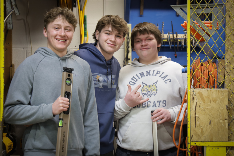 3 students smiling posing together