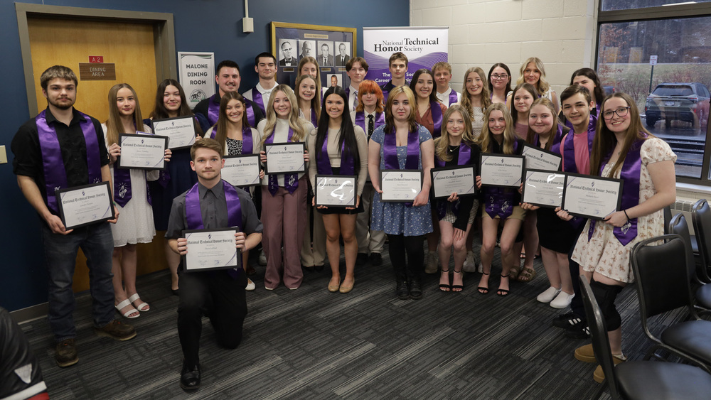 Group of students together with diplomas