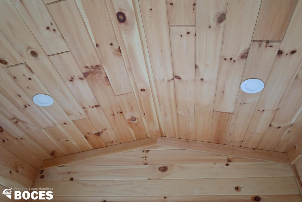 all pine ceiling with internal lights inside the tiny house