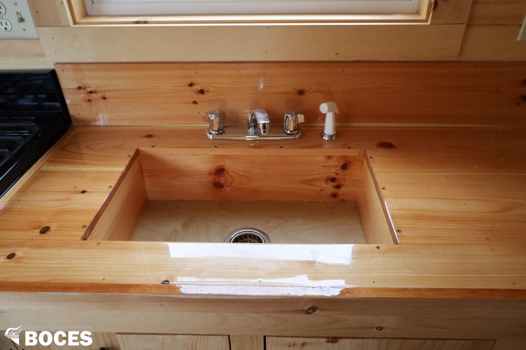 inside the tiny house, pine counter with sink built in
