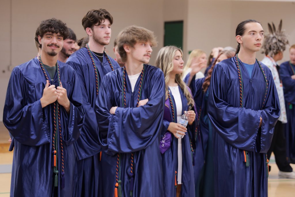 Graduate in group smiles at camera