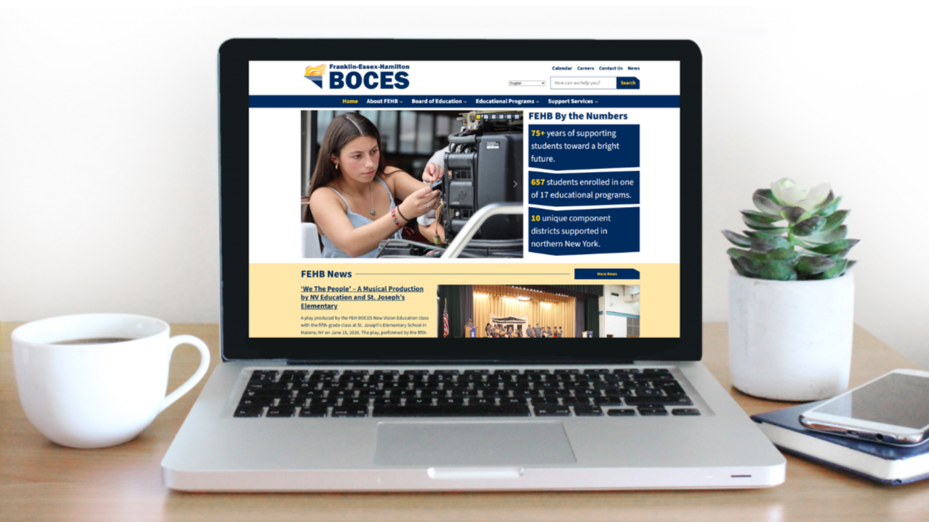 Image of laptop on desk. New FEHB website featured on laptop screen.