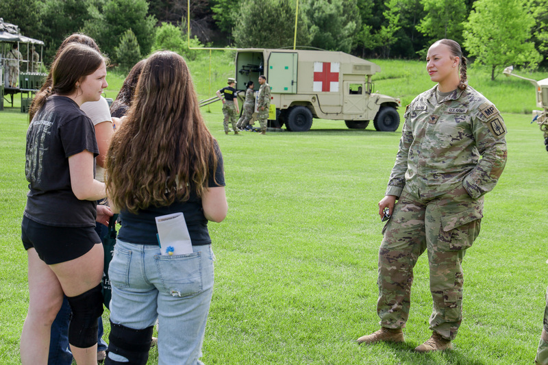 female emergency responder chatting with students