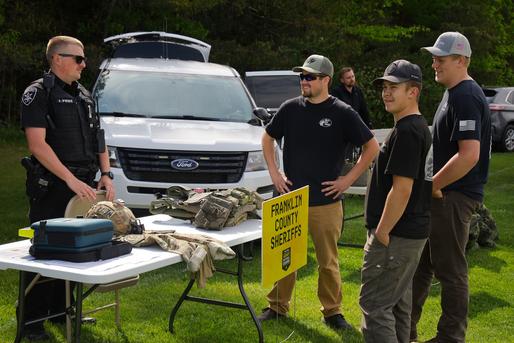 3 Adults speaking with an officer at a table