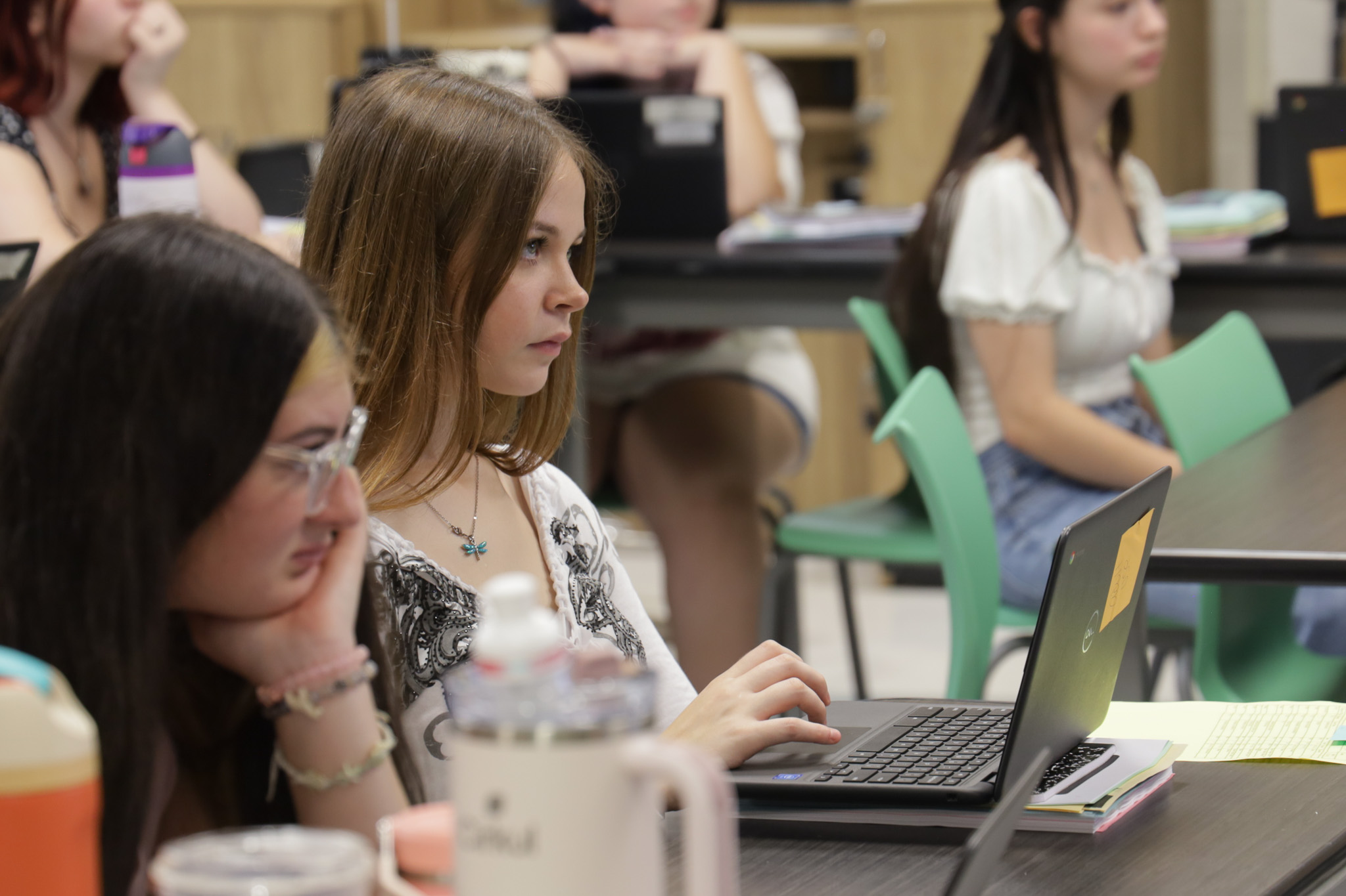 cosmetology students on laptops in classroom